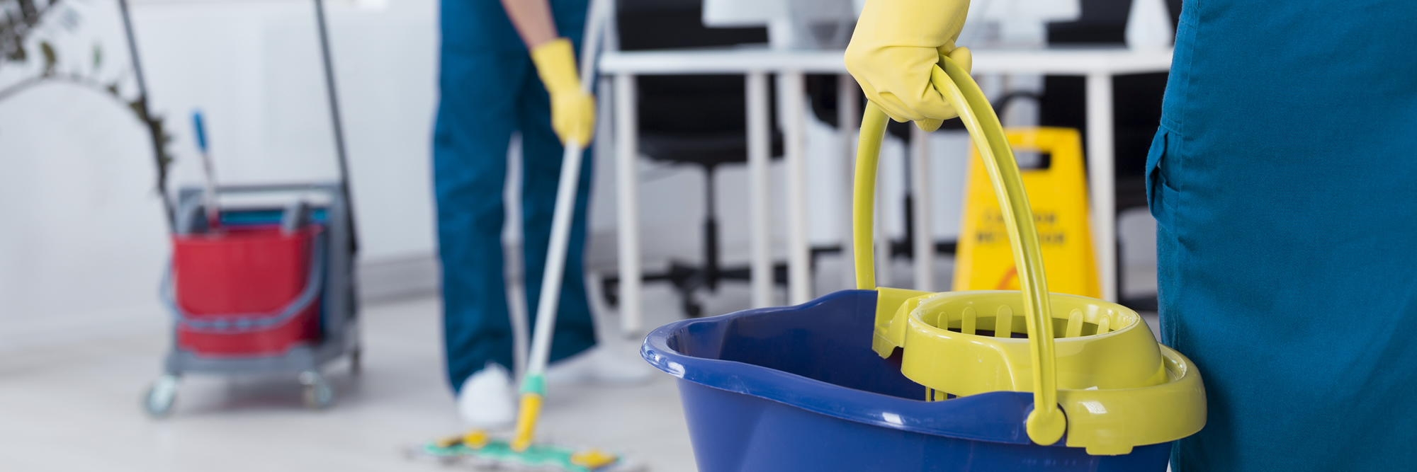 Cleaning services with bucket and mop in office